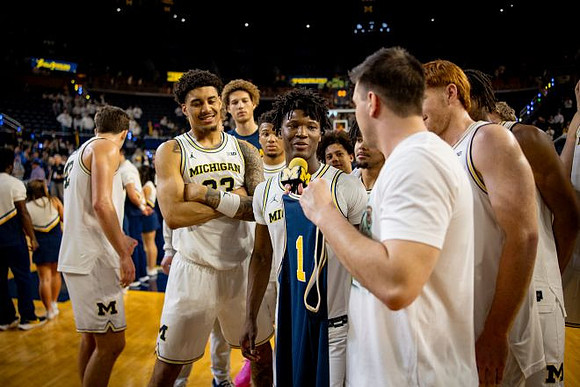 L.J. Cason (2) and Michigan Team