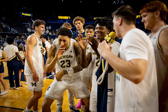 L.J. Cason (2) and Michigan Team