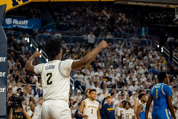 L.J. Cason (2) and Michigan Team