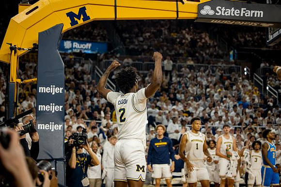 L.J. Cason (2) and Michigan Team