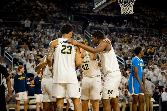 Yaxel Lendeborg (23), Will Tschetter (42), and Morez Johnson Jr. (21)