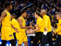 Morez Johnson Jr. (21), Trey McKenney (1), and Dusty May