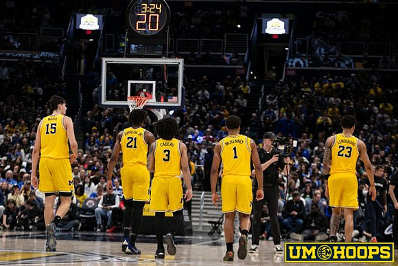 Aday Mara (15), Morez Johnson Jr. (21), Elliot Cadeau (3), Trey McKenney (1), and Yaxel Lendeborg (23)