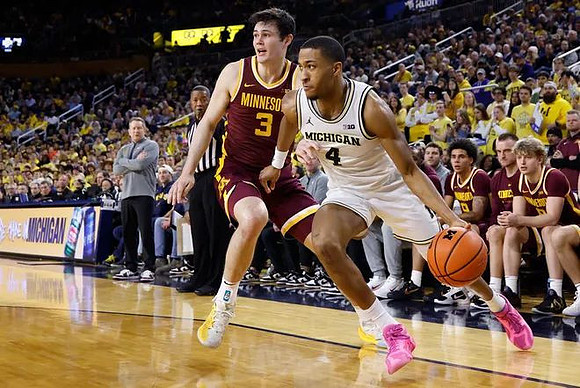 Minnesota Head Coach Niko Medved and Nimari Burnett (4)