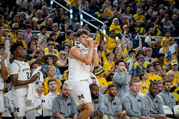 Will Tschetter (42) and Michigan Team