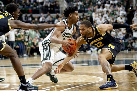 Moussa Diabate (14) and DeVante' Jones (12)