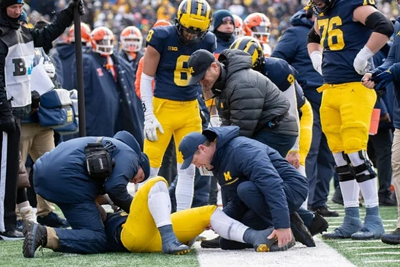 Ronnie Bell (8), Jim Harbaugh, Ryan Hayes (76), J.J. McCarthy (9), and Blake Corum (2)