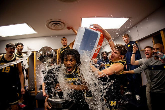 Morez Johnson Jr. (21), Big Ten Championship Trophy, and Michigan Team