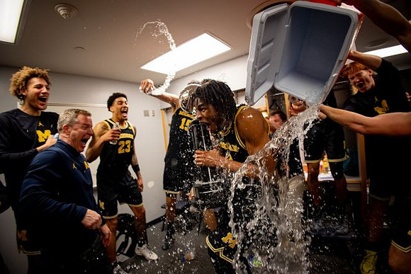 Dusty May, Morez Johnson Jr. (21), Big Ten Championship Trophy, and Michigan Team