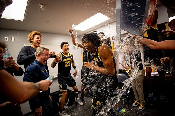 Dusty May, Morez Johnson Jr. (21), Big Ten Championship Trophy, and Michigan Team