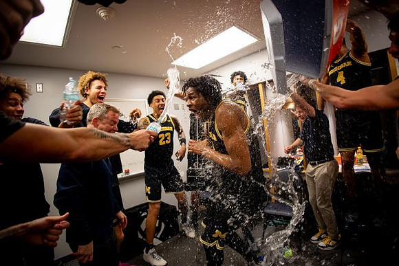 Dusty May, Morez Johnson Jr. (21), Big Ten Championship Trophy, and Michigan Team