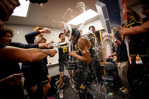 Dusty May, Morez Johnson Jr. (21), Big Ten Championship Trophy, and Michigan Team