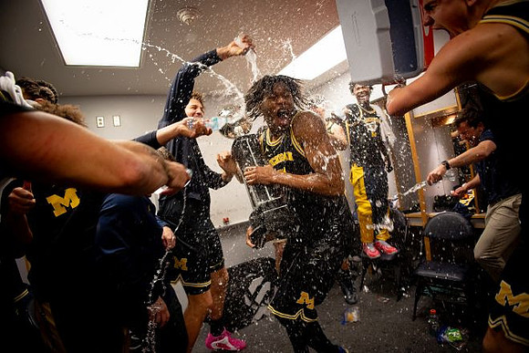 Dusty May, Morez Johnson Jr. (21), Big Ten Championship Trophy, and Michigan Team