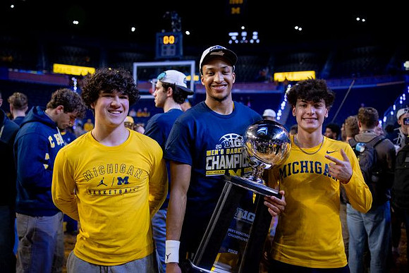 Nimari Burnett (4) and Big Ten Championship Trophy