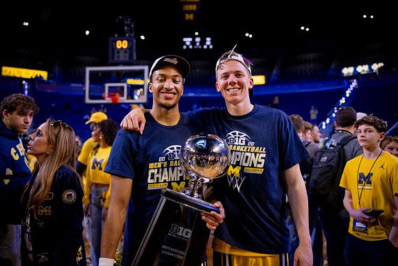 Nimari Burnett (4), Charlie May (12), and Big Ten Championship Trophy