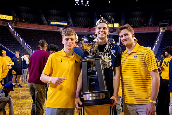 Will Tschetter (42) and Big Ten Championship Trophy