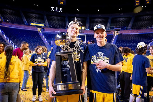 Will Tschetter (42), Charlie May (12), and Big Ten Championship Trophy