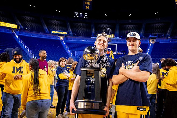 Will Tschetter (42), Charlie May (12), and Big Ten Championship Trophy