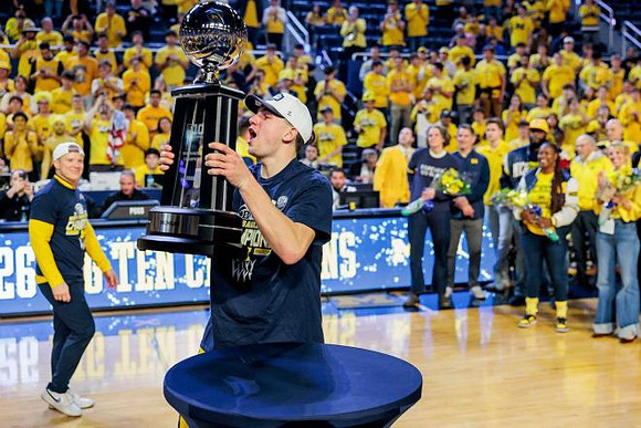 Will Tschetter (42), Big Ten Championship Trophy, and Dusty May