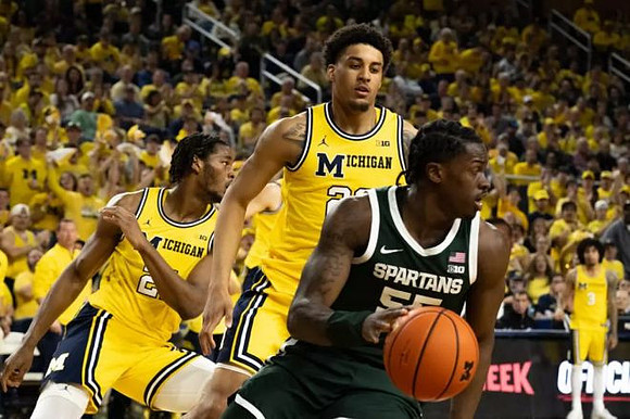 Morez Johnson Jr. (21), Yaxel Lendeborg (23), and Elliot Cadeau (3)