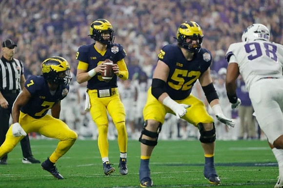 Donovan Edwards (7), J.J. McCarthy (9), and Karsen Barnhart (52)