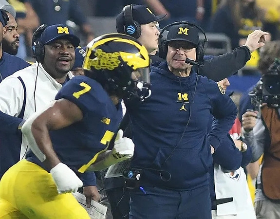 Ron Bellamy, Donovan Edwards (7), and Jim Harbaugh