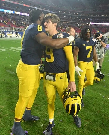 Derrick Moore (8), J.J. McCarthy (9), and Donovan Edwards (7)
