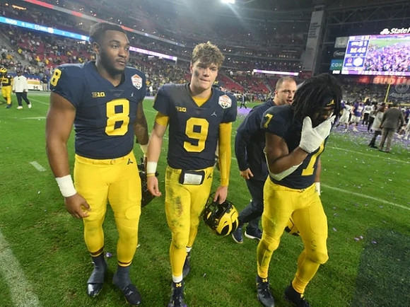 Derrick Moore (8), J.J. McCarthy (9), and Donovan Edwards (7)