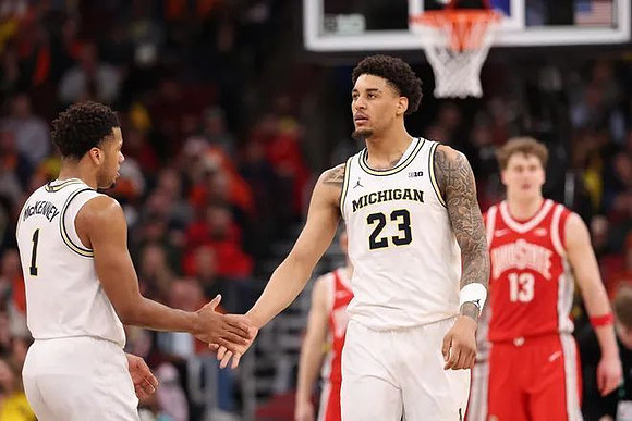 Trey McKenney (1) and Yaxel Lendeborg (23)