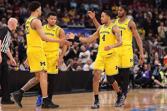 Yaxel Lendeborg (23), Trey McKenney (1), Nimari Burnett (4), and Morez Johnson Jr. (21)
