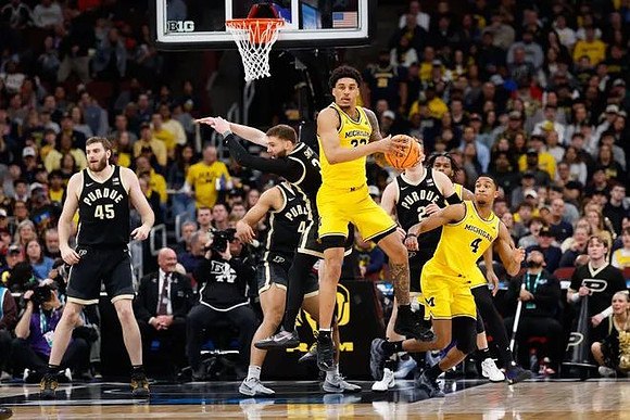 Yaxel Lendeborg (23), Nimari Burnett (4), and Morez Johnson Jr. (21)