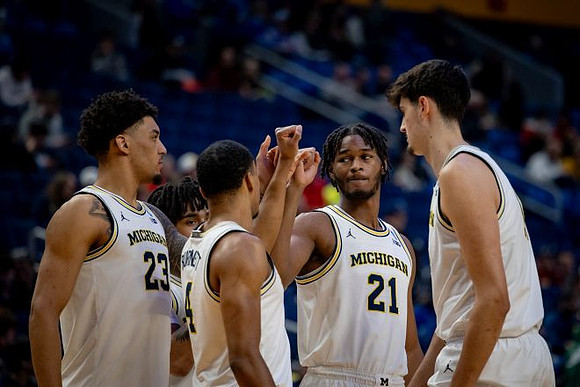 Yaxel Lendeborg (23), Nimari Burnett (4), Morez Johnson Jr. (21), Aday Mara (15), and Elliot Cadeau (3)