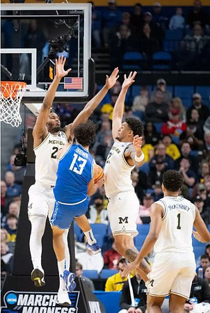 Morez Johnson Jr. (21), Yaxel Lendeborg (23), and Trey McKenney (1)