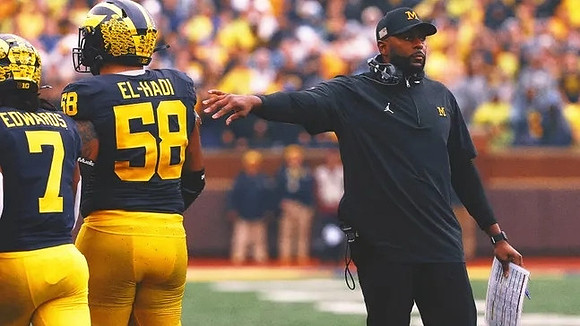 Donovan Edwards (7), Giovanni El-Hadi (58), and Sherrone Moore