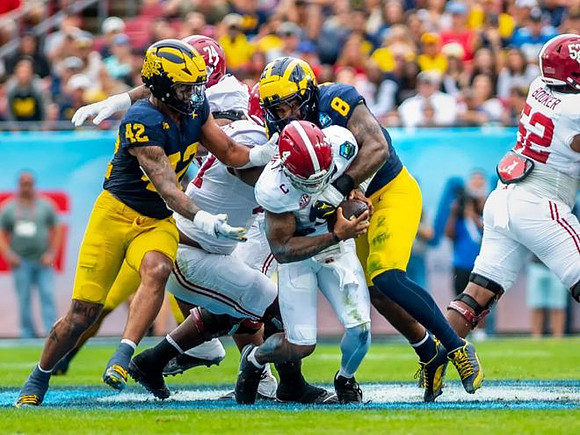 TJ Guy (42) and Derrick Moore (8)