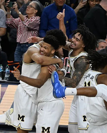 Yaxel Lendeborg (23), Trey McKenney (1), Elliot Cadeau (3), and Morez Johnson Jr. (21)