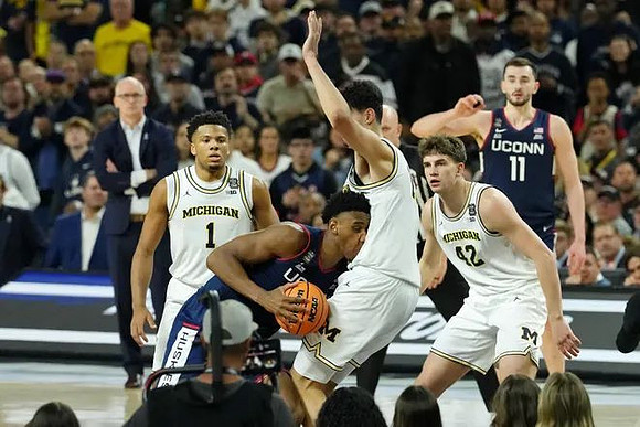 Trey McKenney (1), Aday Mara (15), Will Tschetter (42), and Connecticut Head Coach Dan Hurley