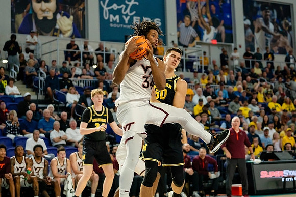 Sam Walters (24), Vladislav Goldin (50), and Virginia Tech Head Coach Mike Young