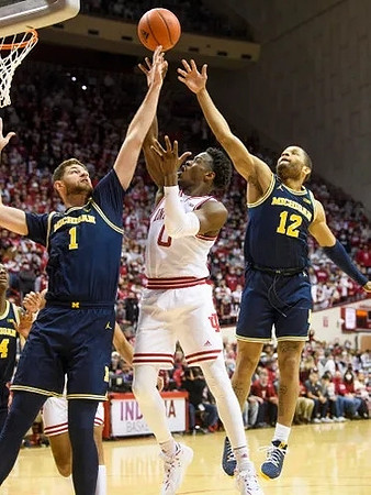 Moussa Diabate (14), Hunter Dickinson (1), and DeVante' Jones (12)