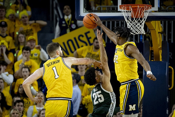 Hunter Dickinson (1) and Tarris Reed Jr. (32)