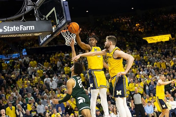 Tarris Reed Jr. (32), Hunter Dickinson (1), and Joey Baker (15)