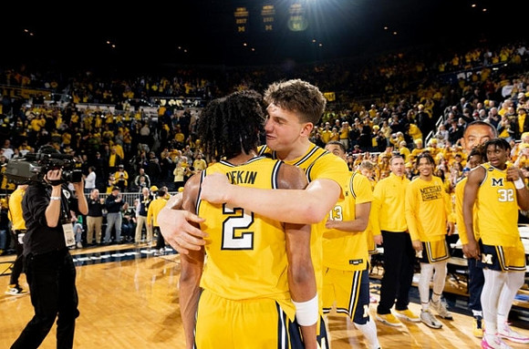Kobe Bufkin (2), Will Tschetter (42), and Michigan Team