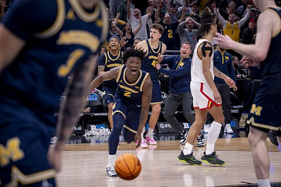 L.J. Cason (2) and Michigan Team