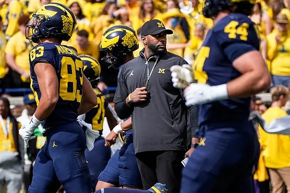 Zack Marshall (83), Sherrone Moore, and Max Bredeson (44)
