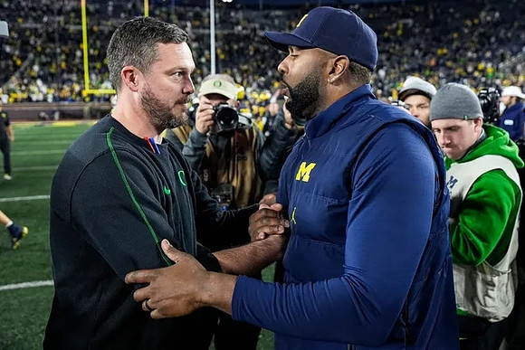 Oregon Head Coach Dan Lanning and Sherrone Moore