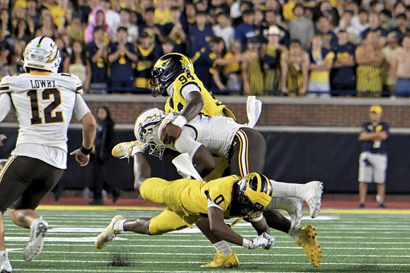 Nate Marshall (94) and Jyaire Hill (0)