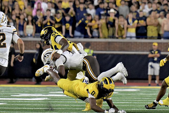Nate Marshall (94) and Jyaire Hill (0)