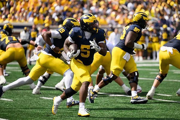 Blake Frazier (77), Bryce Underwood (19), Savion Hiter (5), and Nathan Efobi (55)