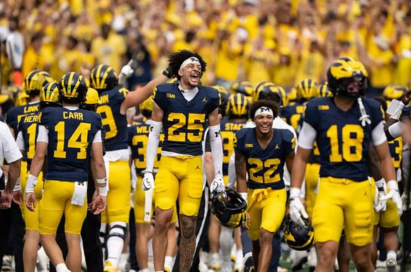 Mason Curtis (25) and Michigan Team
