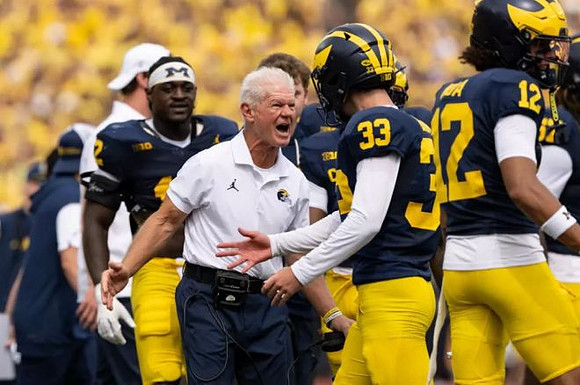 Cam Brown (33) and Michigan Team